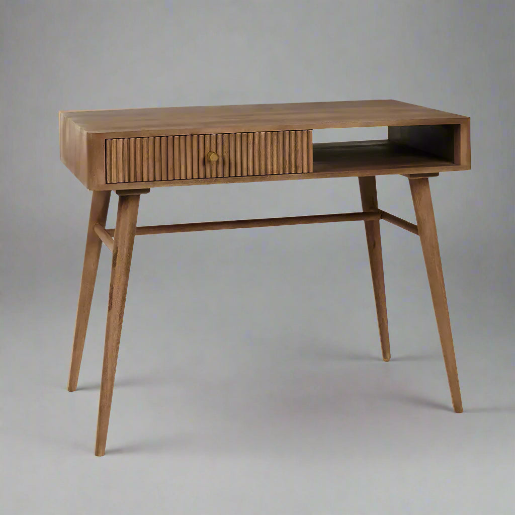 Pillar study table by house of woodworm with a drawer and open storage shelf made of solid wood with wood turned tapered legs in honey finish