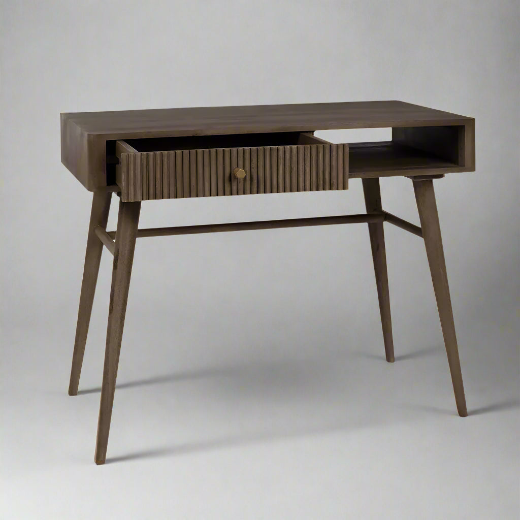 Pillar study table by house of woodworm with a drawer and open storage shelf made of solid wood with wood turned tapered legs in walnut finish