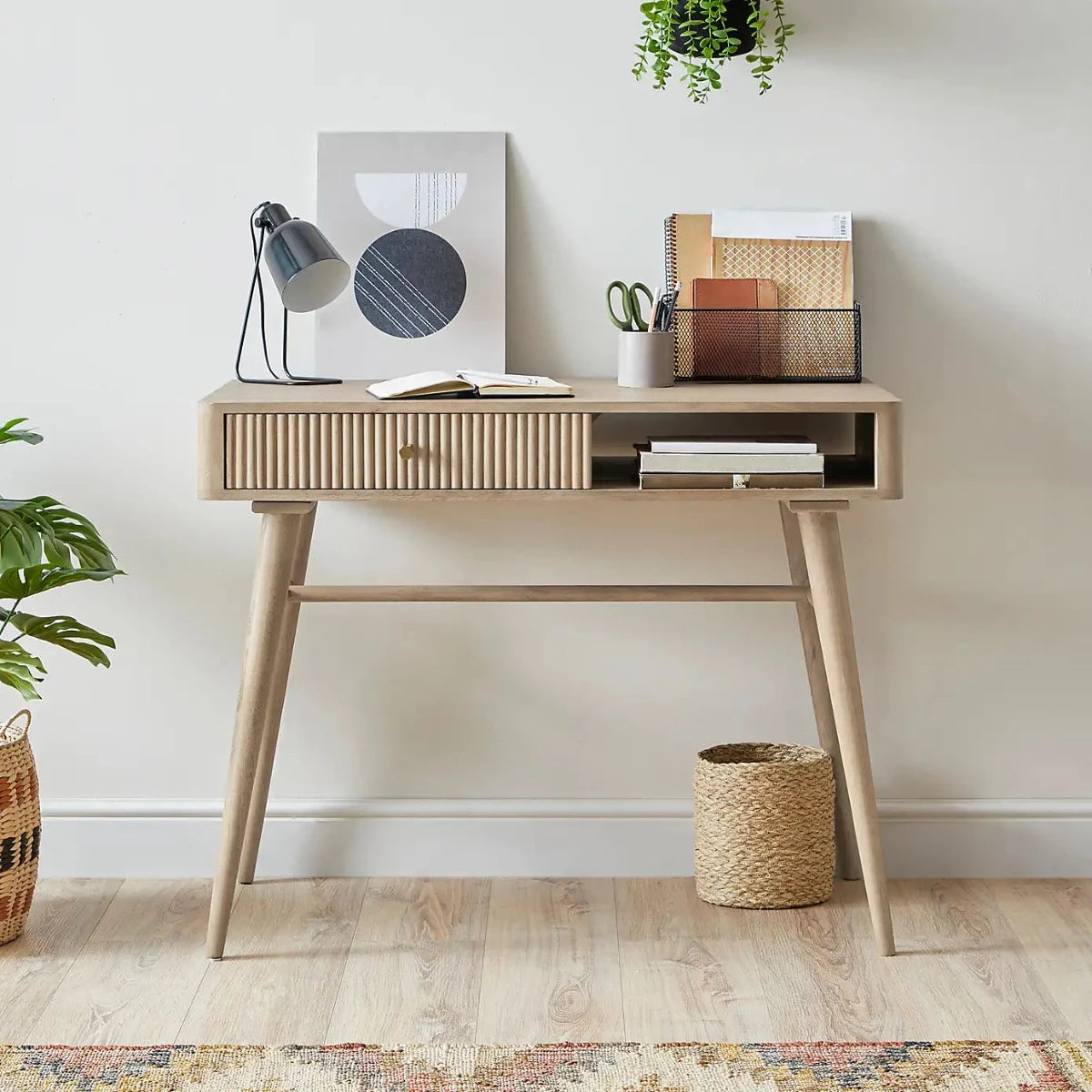 Pillar study table by house of woodworm with a drawer and open storage shelf made of solid wood with wood turned tapered legs in natural finish